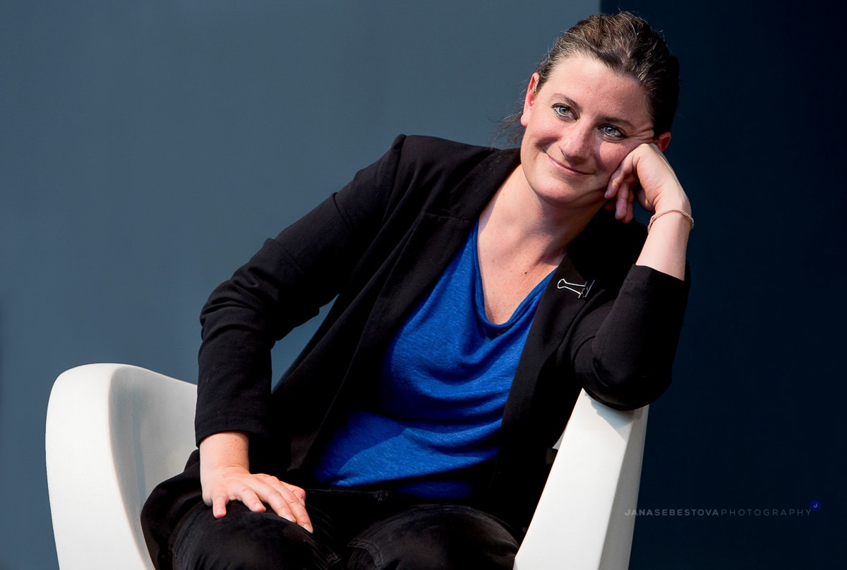 woman sitting smiling in the armchair during a conference