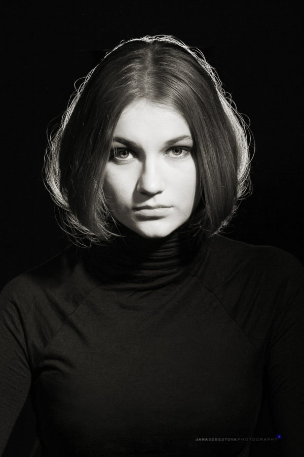 studio portrait of young woman in black and white