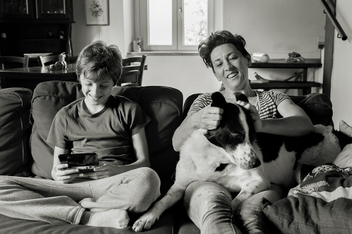 mother with son on the sofa with a dog