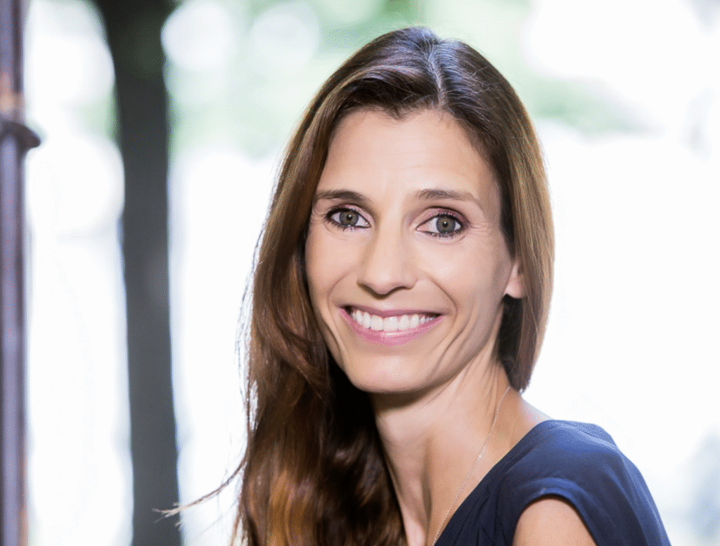 smiling woman with long hair with blurred background