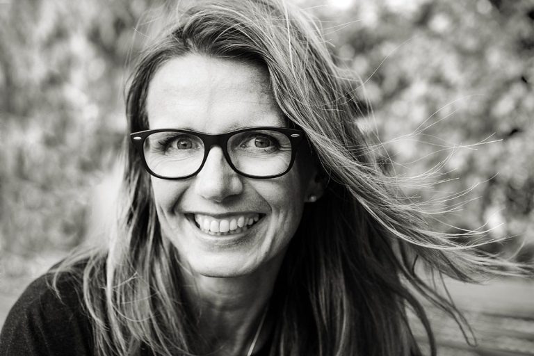 personal portrait solar smiling close up portrait of woman with glasses