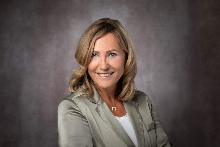 corporate headshot of blond adult woman in natural colors